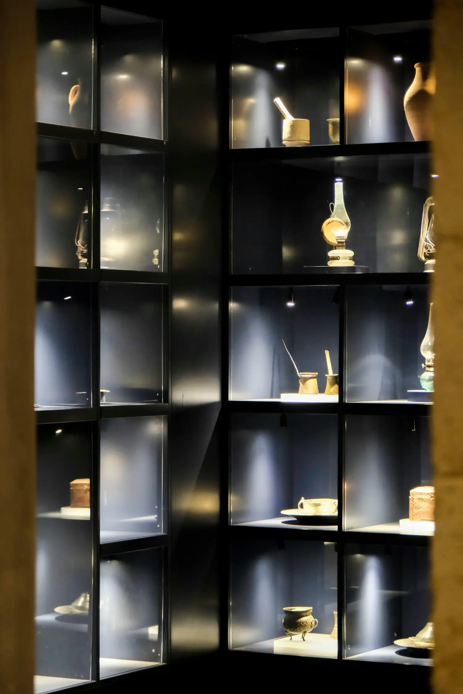 Ein sensibles historisches Kleidungsstück wird in einer rahmenlosen Glasvitrine geschützt ausgestellt.